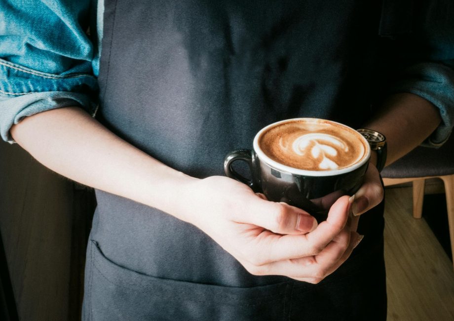 woman holding mug of cappuccino